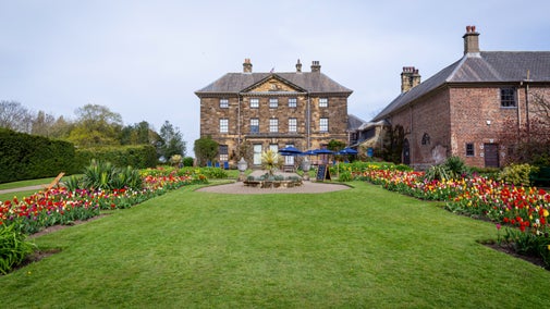 The south facing garden at Ormesby Hall with colourful tulips in front of the house